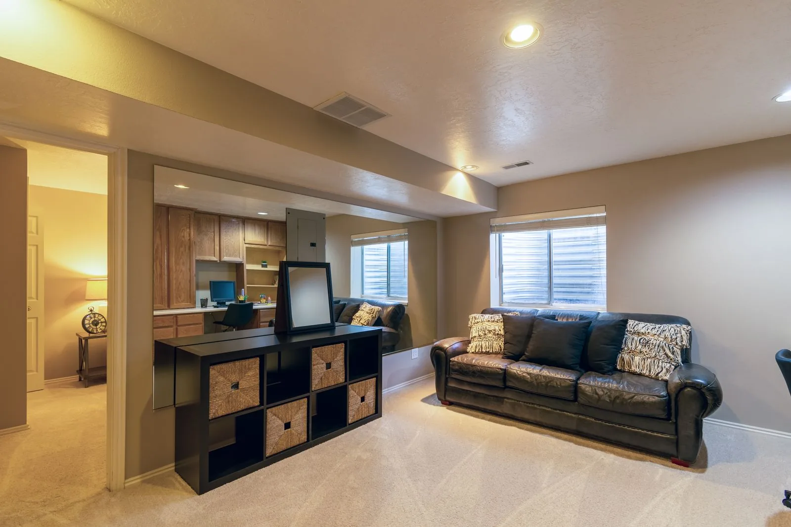 Warm basement living room with leather sofa and modern decor