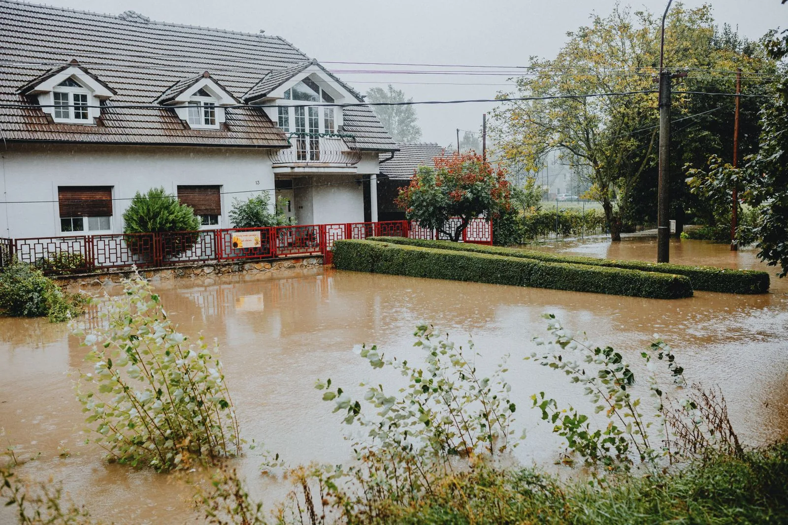 Suburban house surrounded by floodwaters after heavy rain