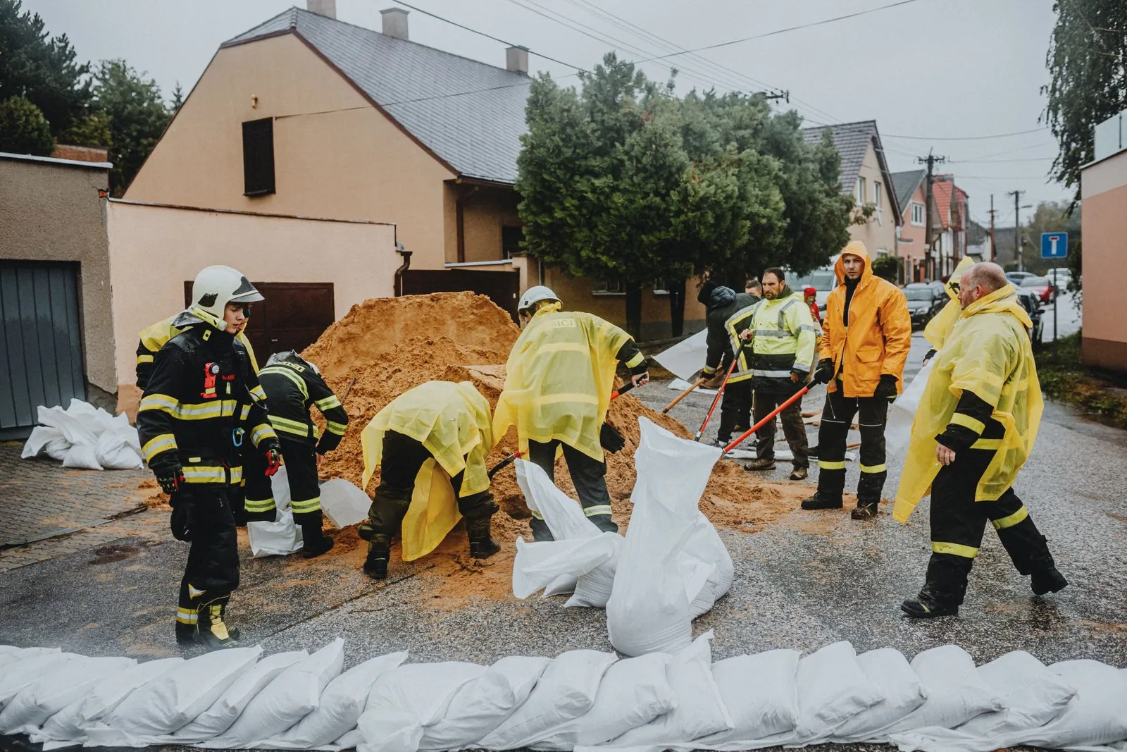 Emergency workers preparing sandbags for flood control